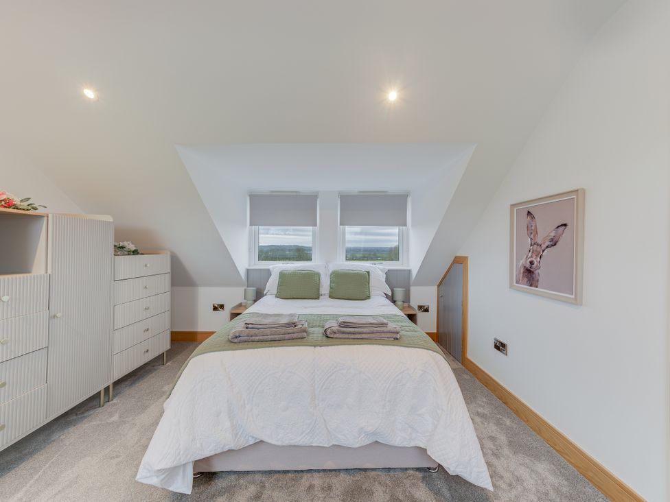 A bedroom with a bed and dresser at Greenacres Farm in Harriseahead near Mow Cop