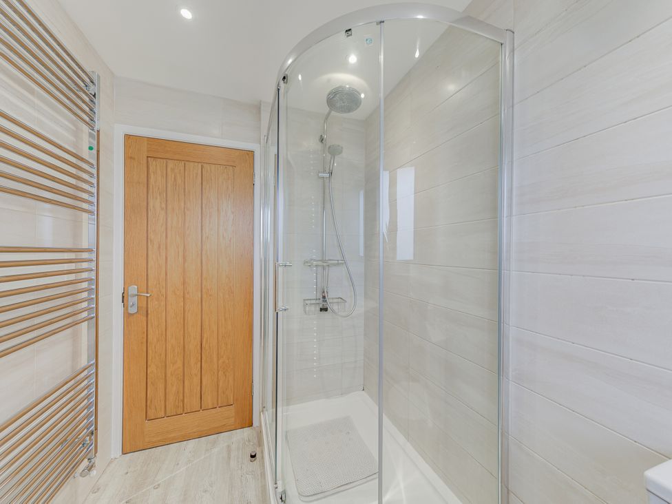 A bathroom with a shower and towel radiator at Greenacres Farm Harriseahead near Mow Cop