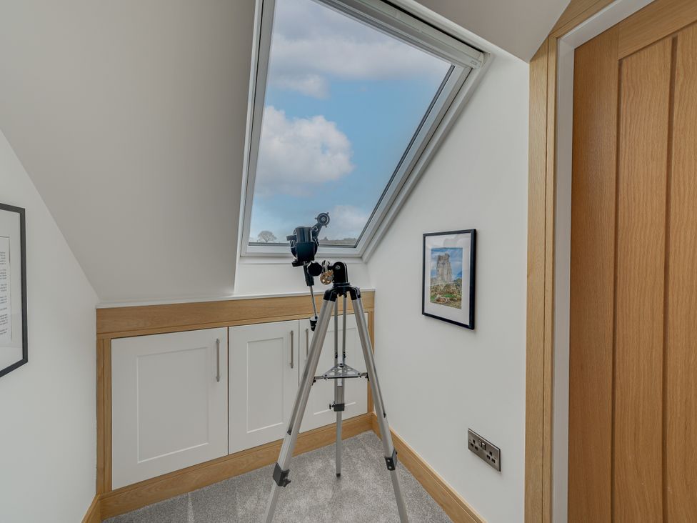 An attic with a telescope and window at Greenacres Farm Harriseahead near Mow Cop