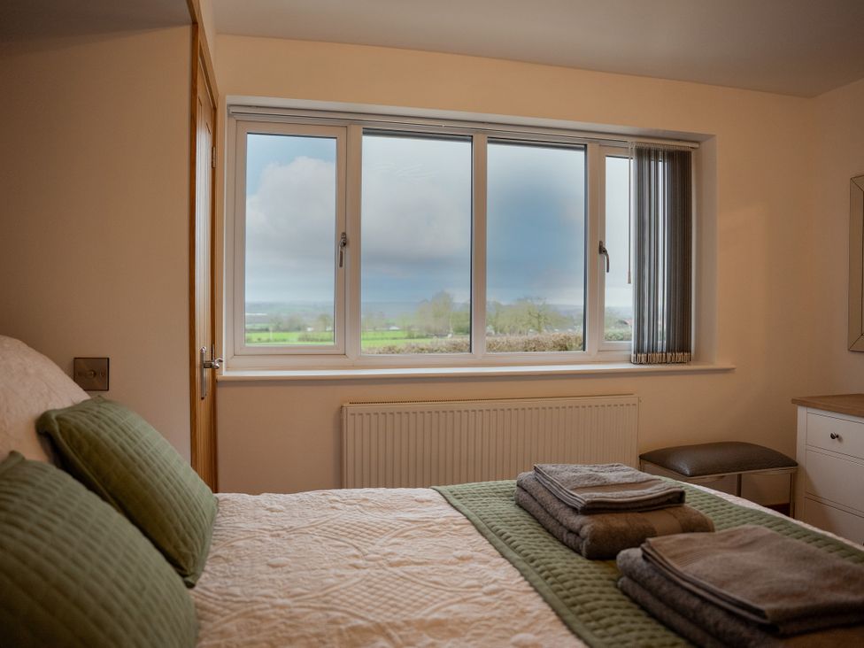 A bedroom with a bed and towels on it at Greenacres Farm in Harriseahead near Mow Cop
