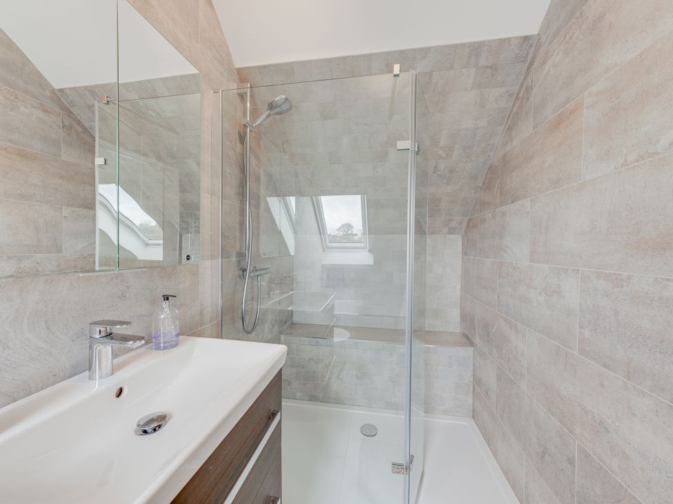 A bathroom with a shower and sink at Greenacres Farm in Harriseahead near Mow Cop