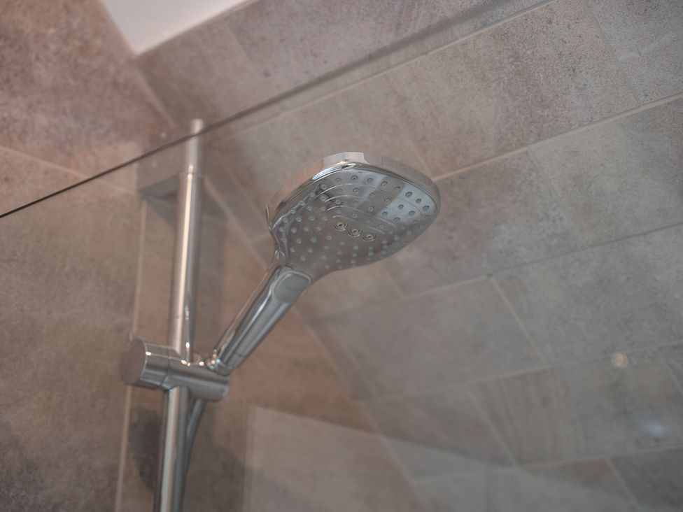 A shower head with glass partition at Greenacres Farm Harriseahead near Mow Cop