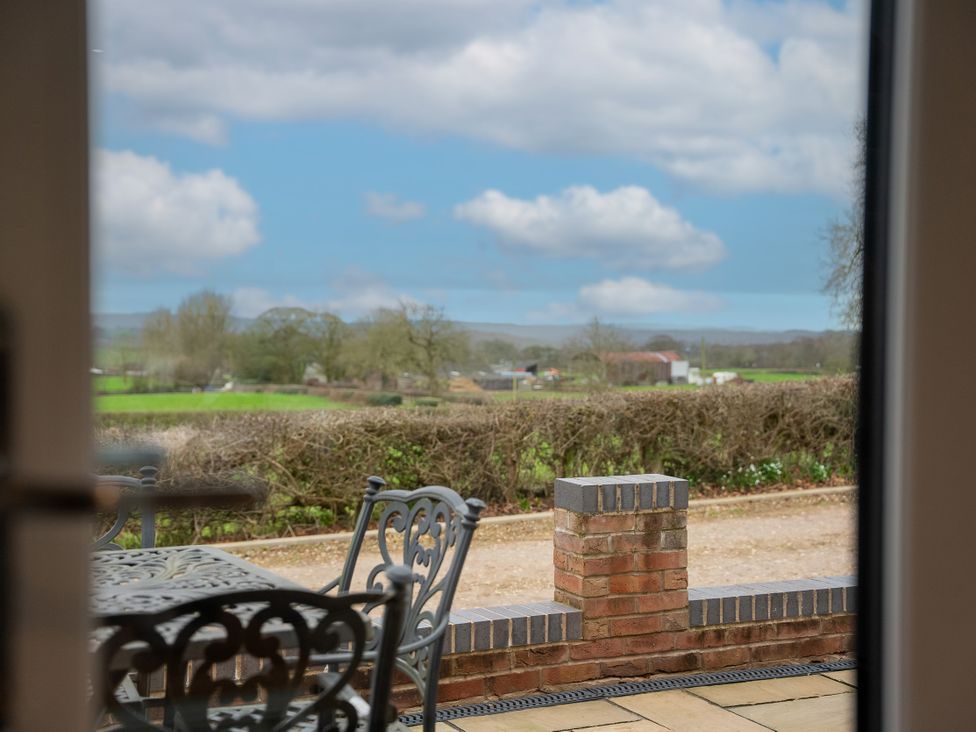 An outdoor view with a table and chair at Greenacres Farm Harriseahead near Mow Cop