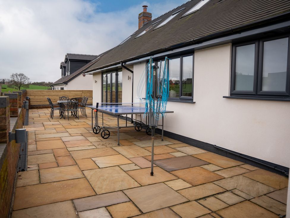 A patio with a table and chairs at Greenacres Farm Harriseahead near Mow Cop