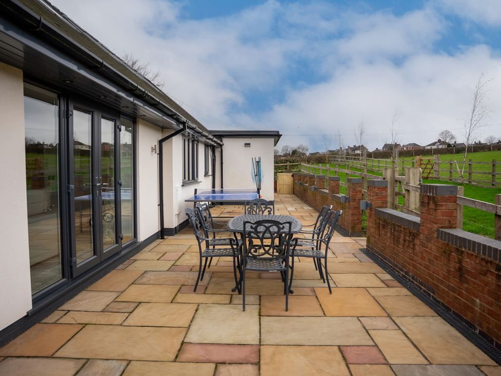 An outdoor area with a table and chairs at Greenacres Farm Harriseahead near Mow Cop