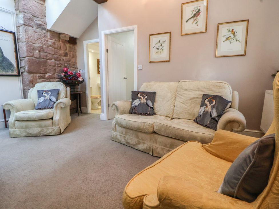 A living room with sofas and artwork at The Jewel In The Crown near Biddulph Moor