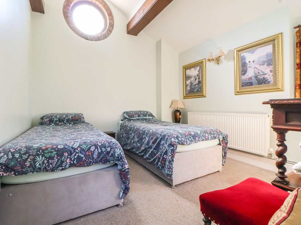 A bedroom with two beds and a lamp at The Jewel In The Crown near Biddulph Moor
