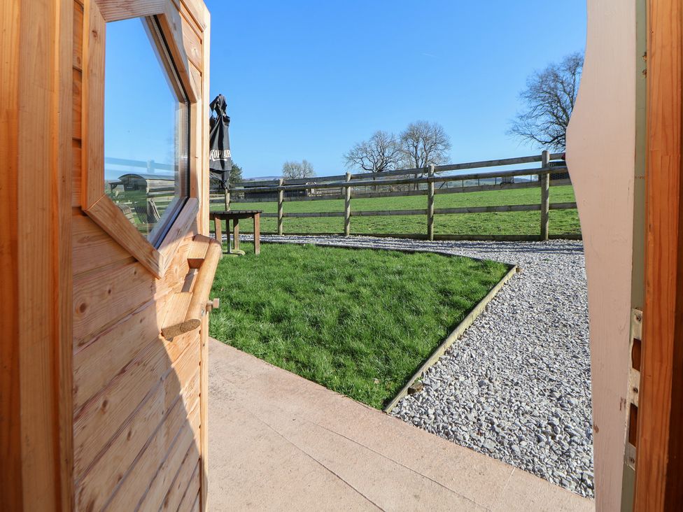 An outdoor area with a view of grass and a fence at Antlers Lodge in Biddulph Moor