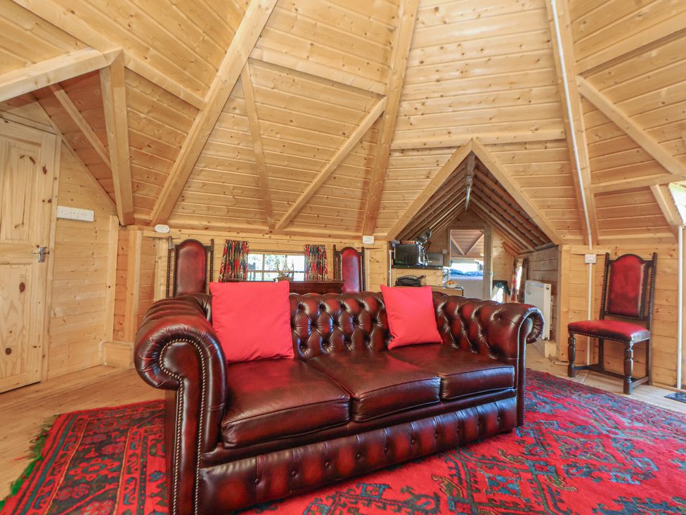 A lounge area with a sofa and chairs at Antlers Lodge in Biddulph Moor