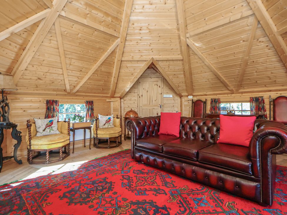 A living room with a sofa and armchairs at Antlers Lodge in Biddulph Moor