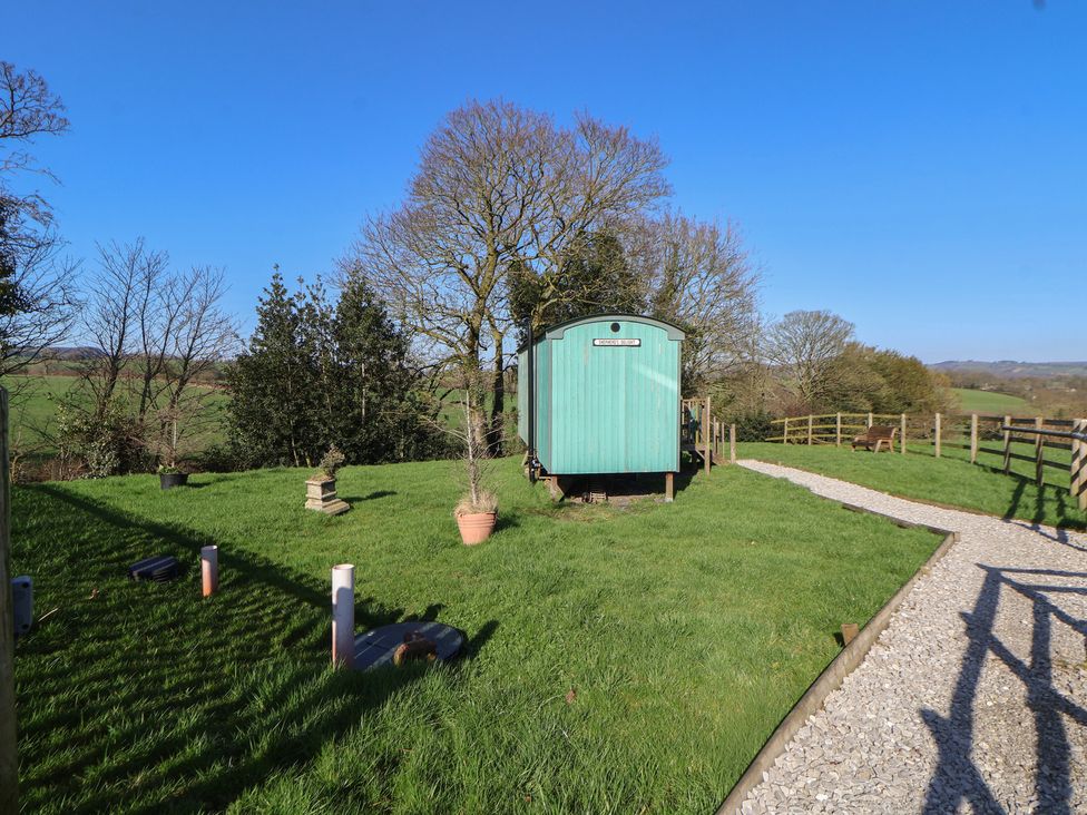 An outdoor view featuring a wagon and trees at Shepherds Delight in Biddulph Moor