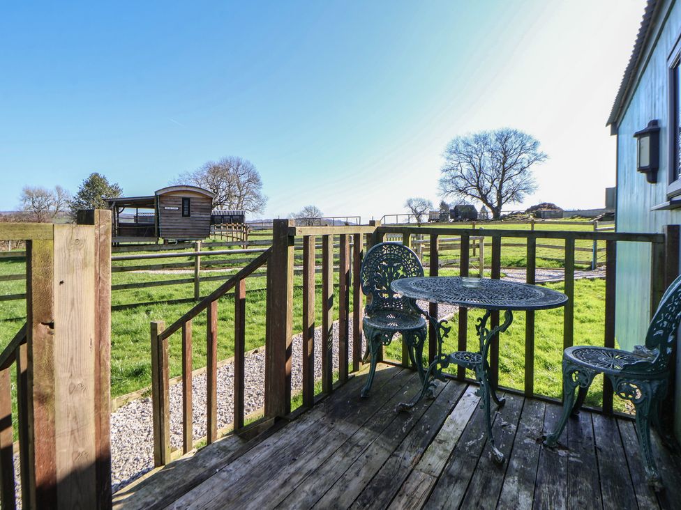 An outdoor area with a table and chairs at Shepherds Delight in Biddulph Moor