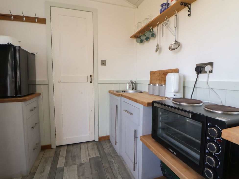 A kitchen with a sink and an oven at Shepherds Delight in Biddulph Moor