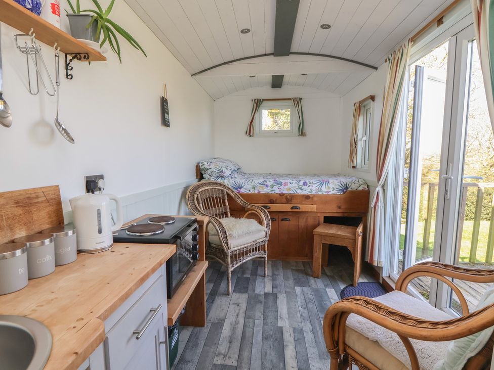 A living room with a bed and furniture at Shepherds Delight in Biddulph Moor