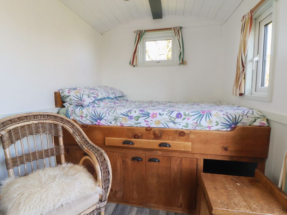 A bedroom with a bed and a chair at Shepherds Delight in Biddulph Moor