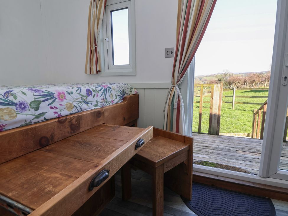 A bedroom with a bed and drawer at Shepherds Delight in Biddulph Moor