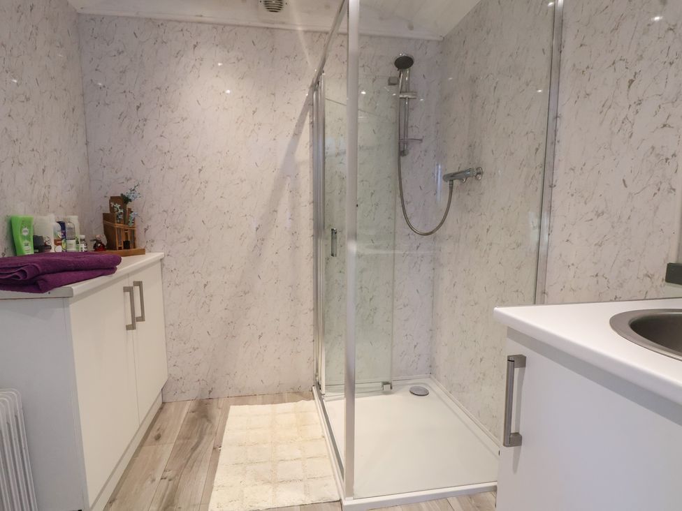 A shower and sink in a bathroom at Shepherds Delight in Biddulph Moor