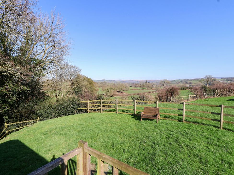 An outdoor area with a bench and fence at Shepherds Delight in Biddulph Moor
