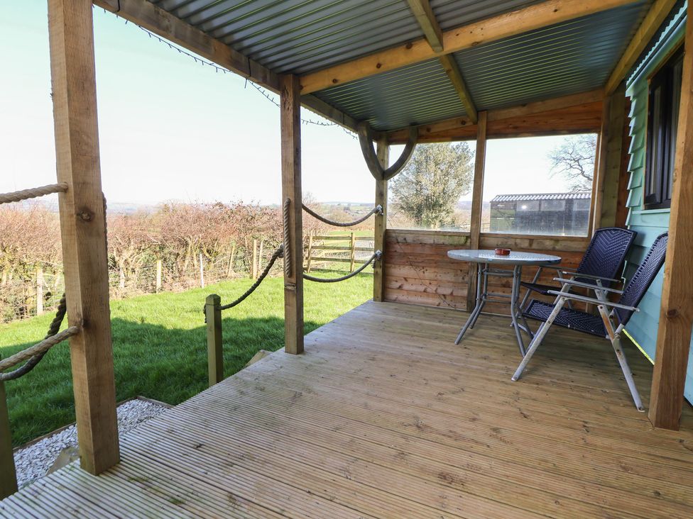 An outdoor patio with a table and chairs at Golden Fleece in Biddulph Moor