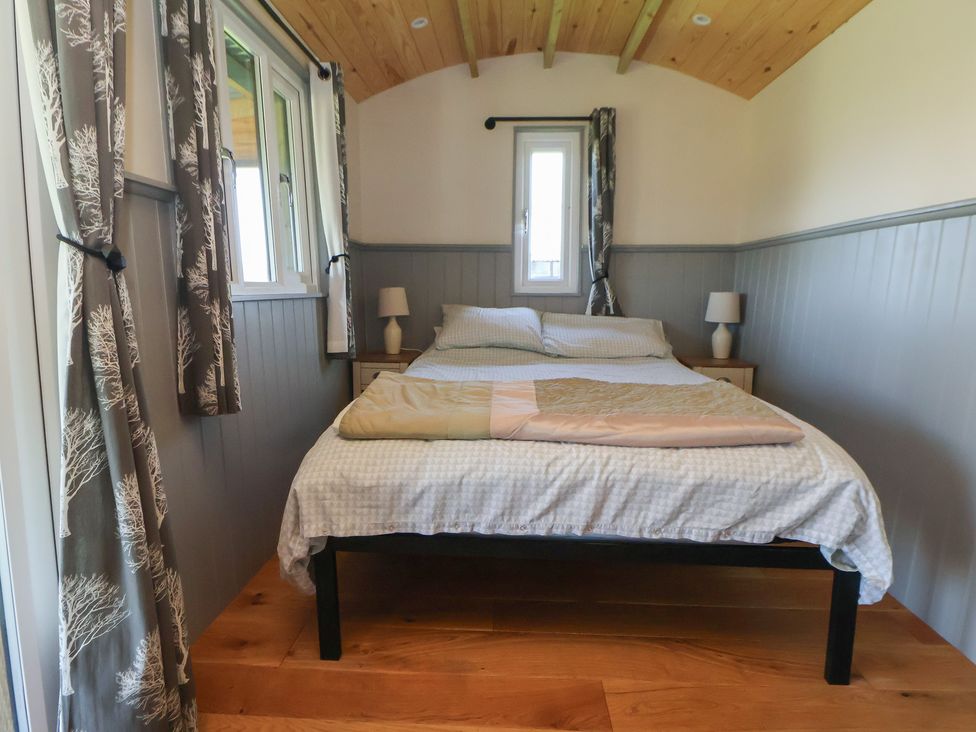 A bedroom with a bed and lamp at Golden Fleece in Biddulph Moor