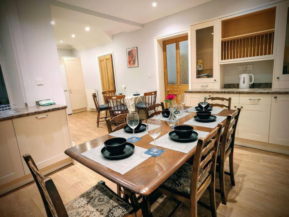 A dining room with a table set for dinner at 4 The Croft in Hexham
