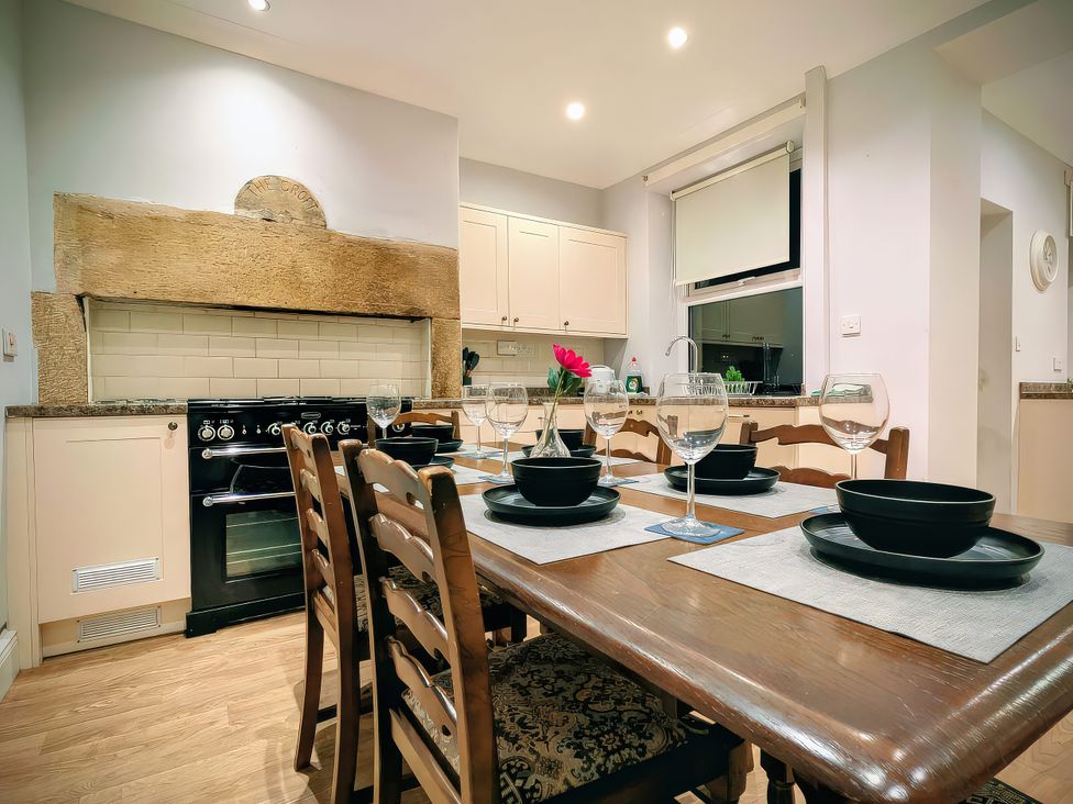 A kitchen with a dining table and chairs at 4 The Croft in Hexham