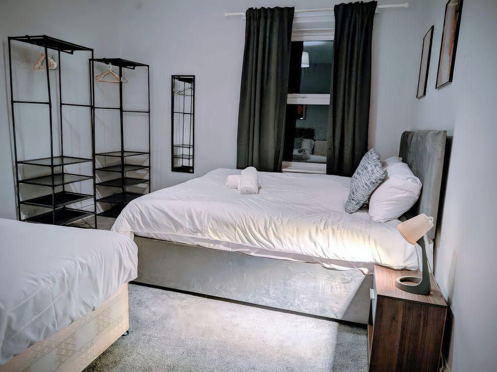 A bedroom with a bed and wardrobe at 4 The Croft in Hexham