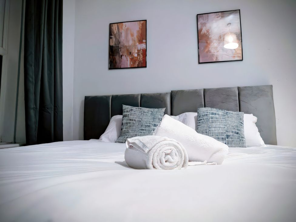 A bedroom with a bed and pillows at 4 The Croft Hexham