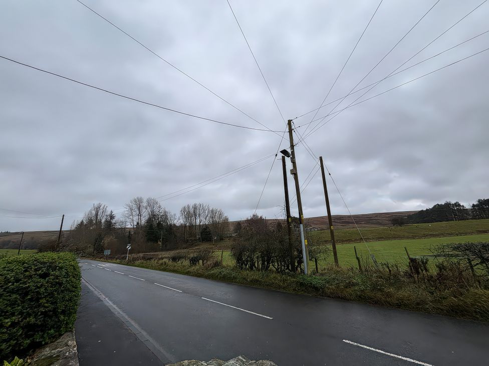 A road with electric poles and fields at 4 The Croft in Hexham