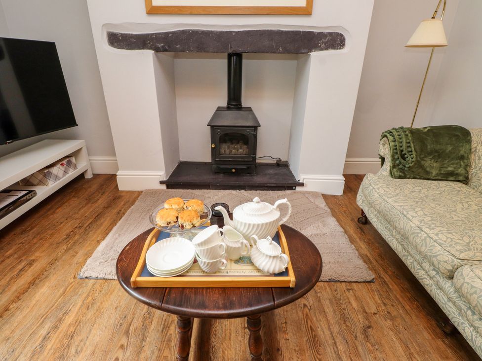 A living room with a fireplace and tea set at 3 Tre Felin Llandygai near Bangor