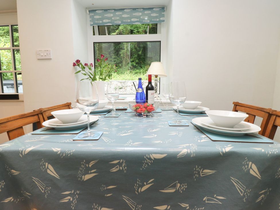 A dining table set with plates and glasses at 3 Tre Felin in Llandygai near Bangor