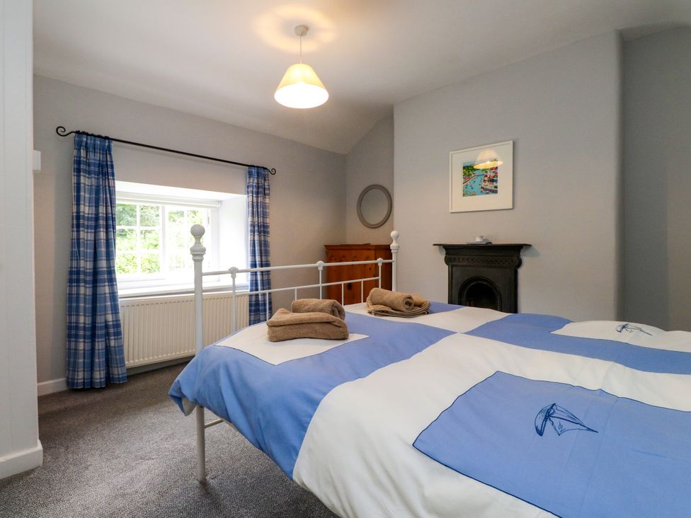 A bedroom with a double bed and accessories at 3 Tre Felin Llandygai near Bangor