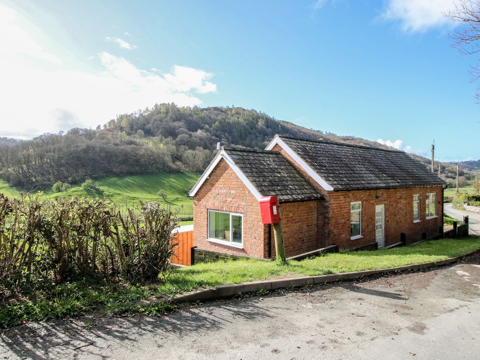 A house with a mailbox and a scenic background at Spring Bank in Llanfyllin