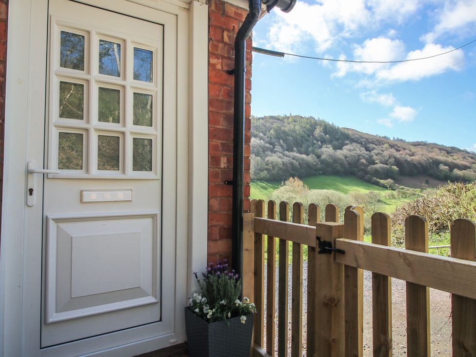 A door with a fence and a planter at Spring Bank in Llanfyllin
