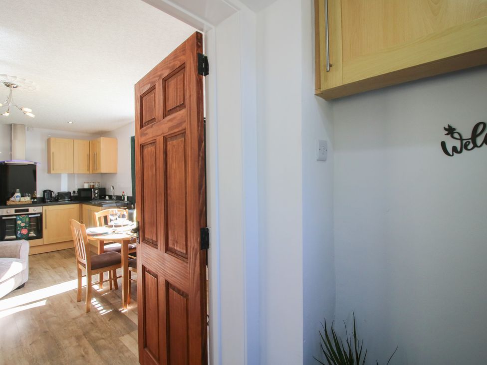 A kitchen view with a table and chairs at Spring Bank in Llanfyllin