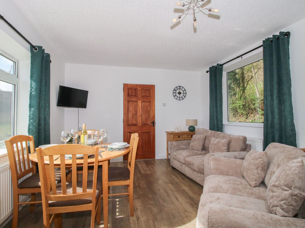 A dining room with a table and chairs at Spring Bank in Llanfyllin