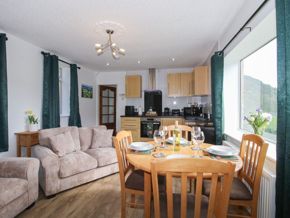 A dining room with a table and chairs at Spring Bank in Llanfyllin
