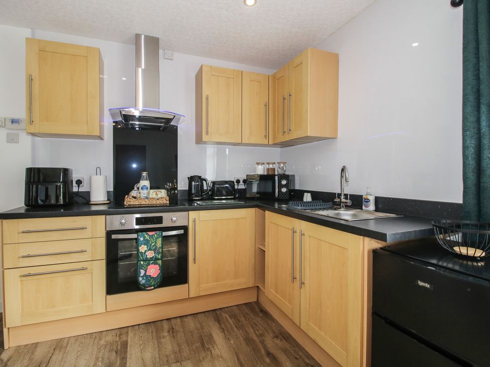 A kitchen with cabinets and appliances at Spring Bank in Llanfyllin