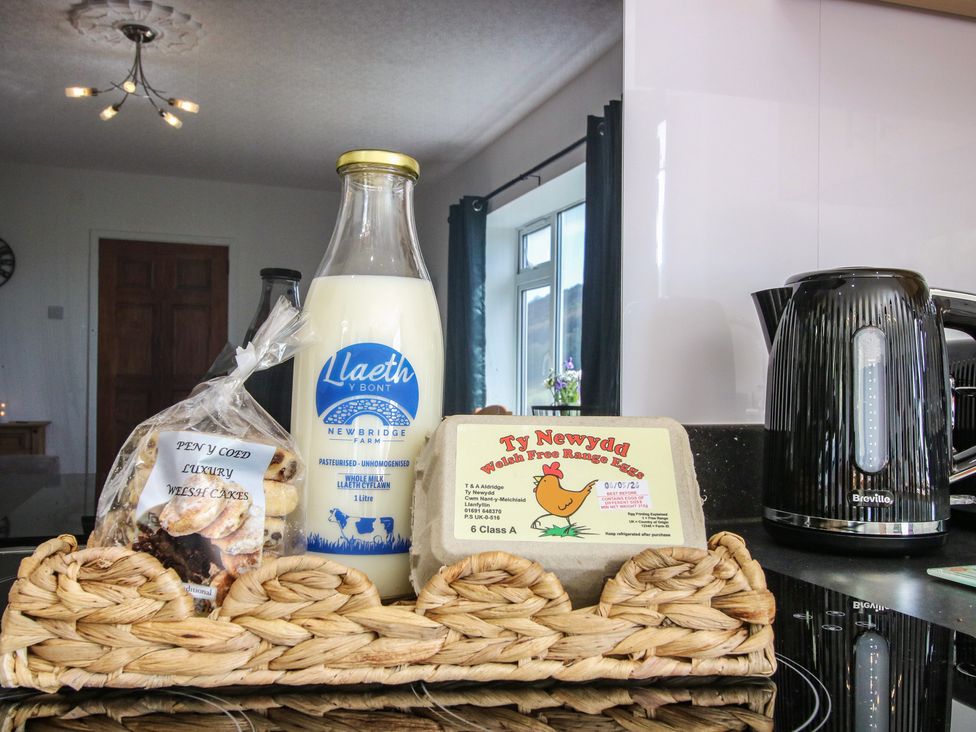 A kitchen counter with milk, eggs, biscuits, and a kettle at Spring Bank in Llanfyllin