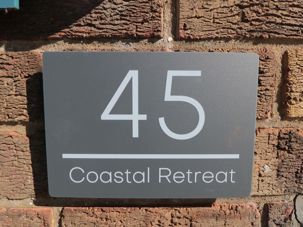A house number and name sign at Coastal Retreat in Scarborough