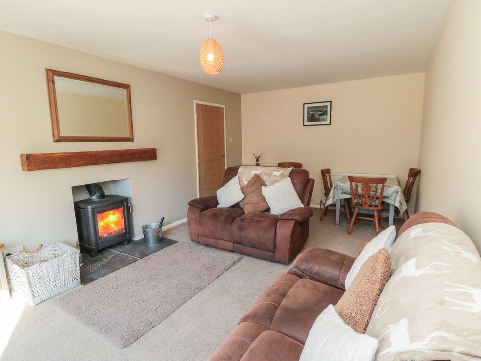 A living room with a fireplace and seating area at Coastal Retreat in Scarborough