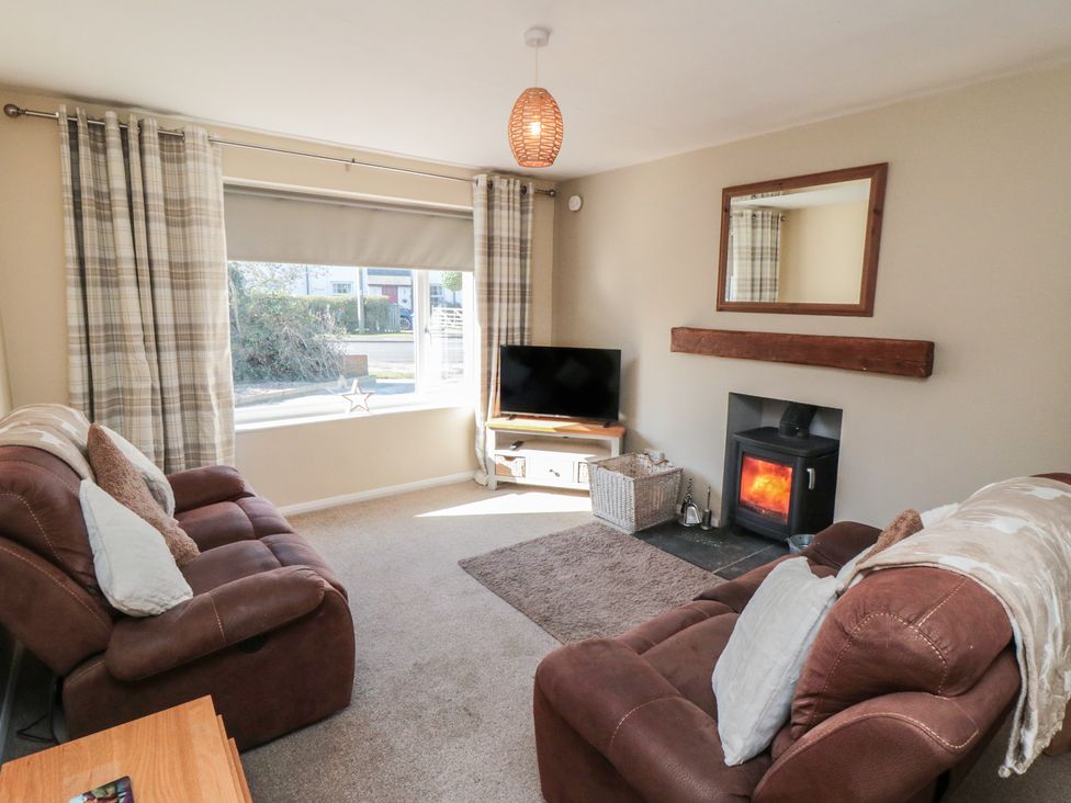 A living room with a sofa and television at Coastal Retreat in Scarborough