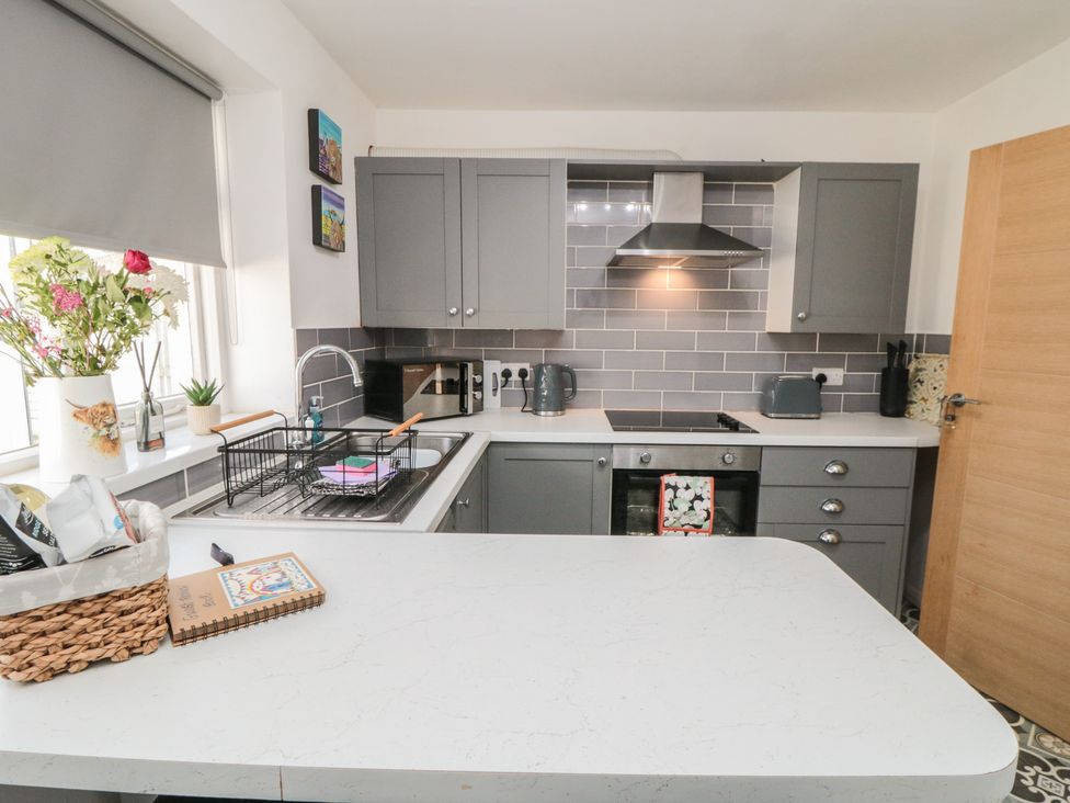 A kitchen with cabinets, sink, and countertop at Coastal Retreat in Scarborough
