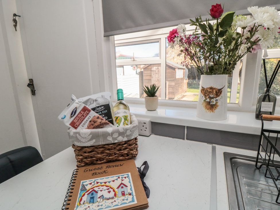 Basket with cookies and wine on the kitchen counter at Coastal Retreat in Scarborough