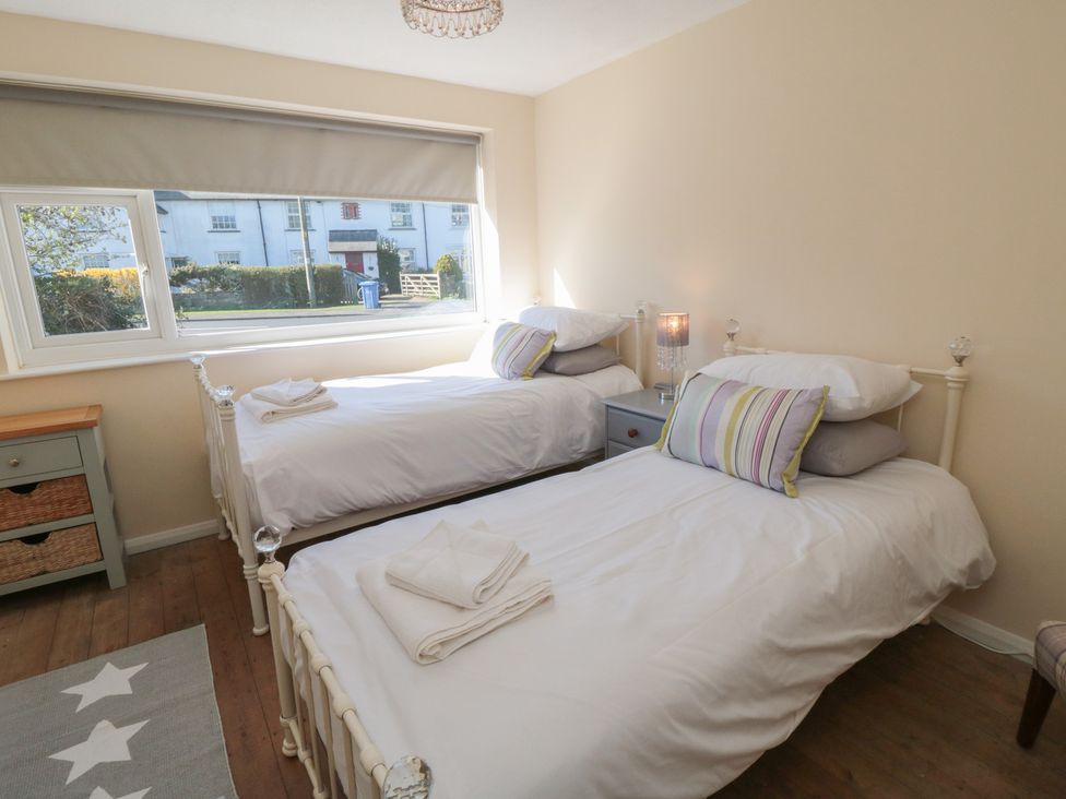 A bedroom with two single beds and a window at Coastal Retreat in Scarborough