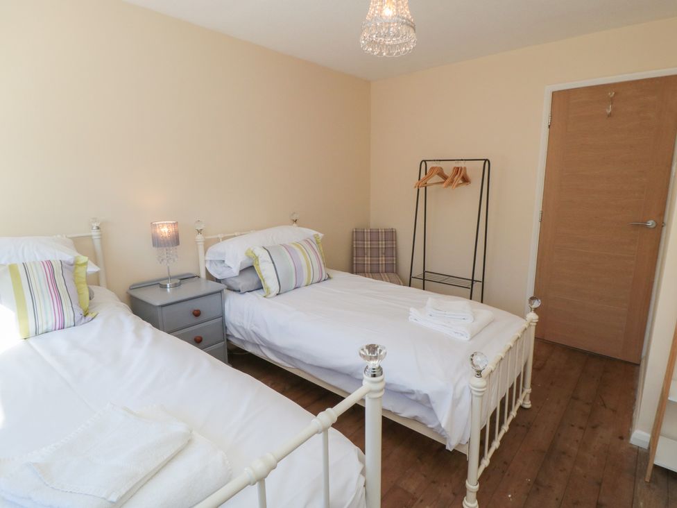 A bedroom with two beds and a nightstand at Coastal Retreat in Scarborough