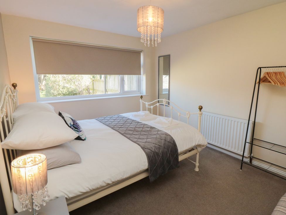 A bedroom with a bed and lamp at Coastal Retreat in Scarborough