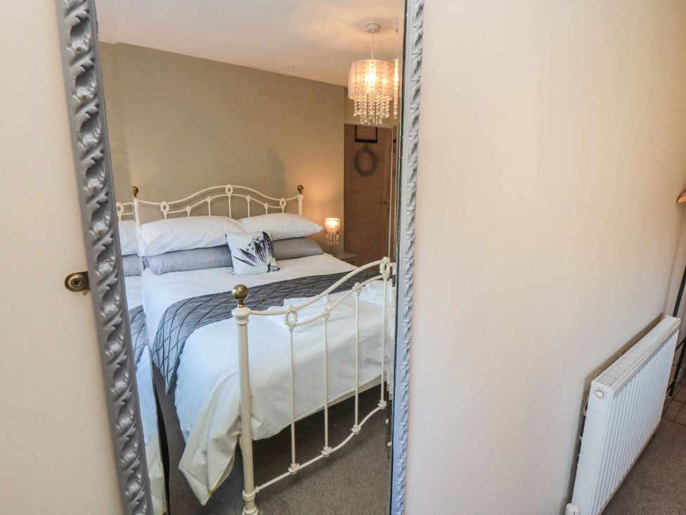 A bedroom with a bed and bedside table at Coastal Retreat in Scarborough