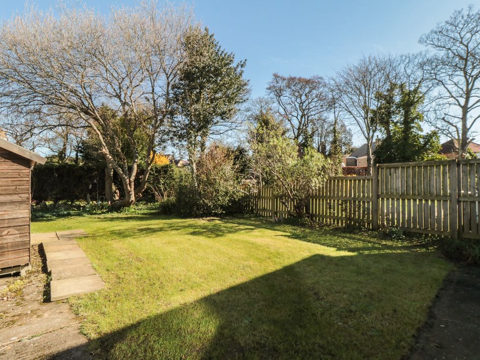 A garden with grass and trees at Coastal Retreat in Scarborough