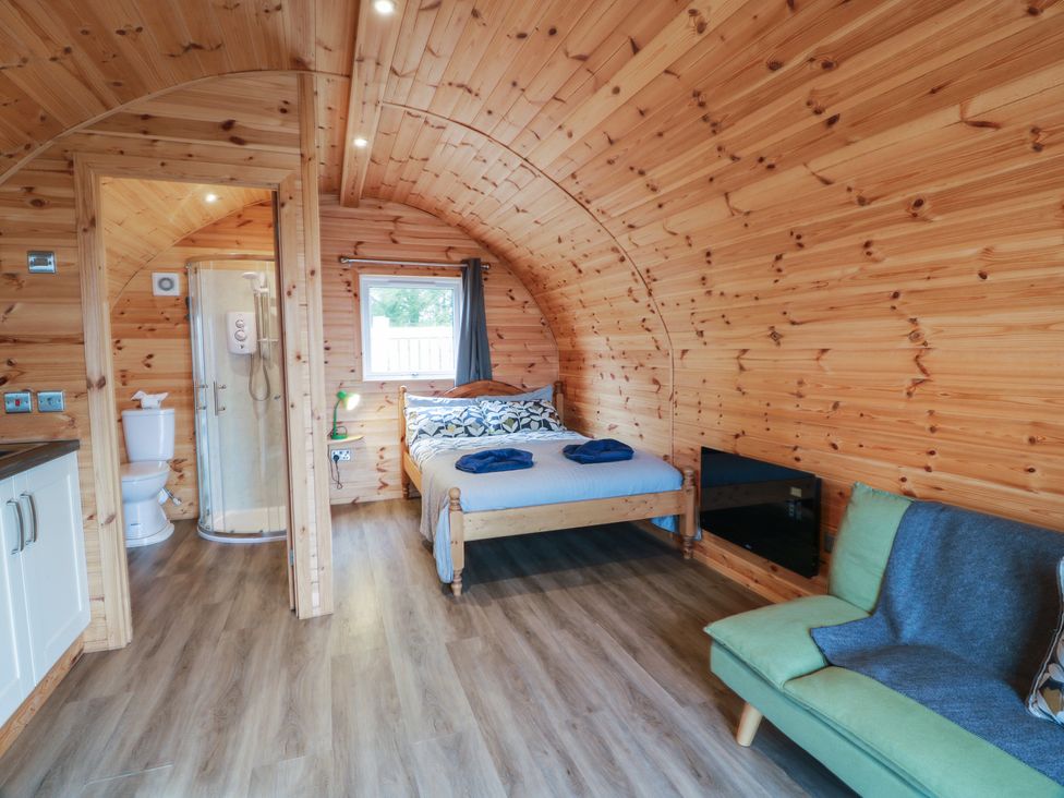 A studio with a bed, shower and seating at Douglas in Stoneykirk near Sandhead